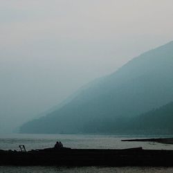 Scenic view of sea with mountains in background