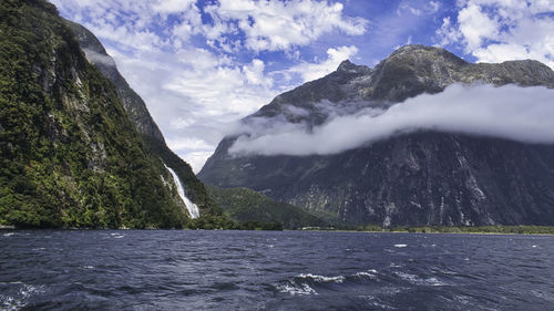 Scenic view of sea and mountains against sky