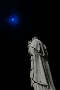 Low angle view of statue against blue sky