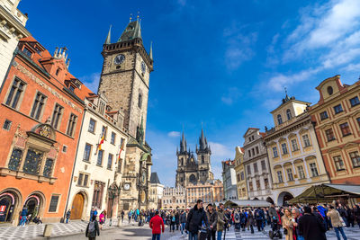 Tourists in front of tyn cathedral and astronomical clock in old town square
