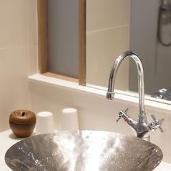 Close-up of faucet in bathroom at home