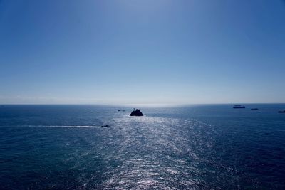 Scenic view of sea against clear blue sky