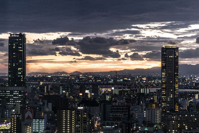 Aerial view of city lit up at sunset