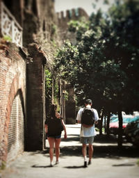 Rear view of people walking on street