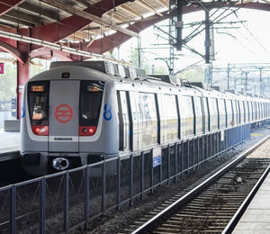 Delhi metro train arriving at jhandewalan metro station in new delhi, india, public metro departing