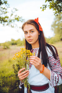 Photo of a smiling young woman in ethnic ukrainian shirt