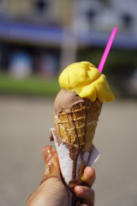 Close-up of hand holding ice cream cone