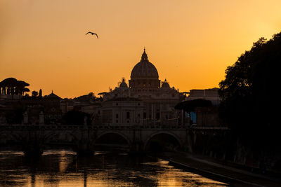 Silhouette of buildings against sky during sunset