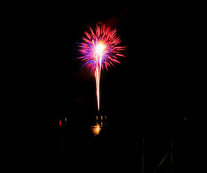 Low angle view of firework display at night