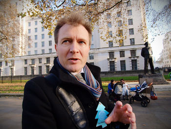 Portrait of man on street in city