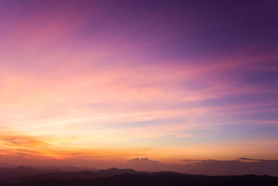 Low angle view of silhouette mountains against romantic sky