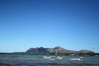 Scenic view of sea against clear blue sky