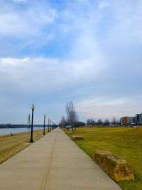 View of empty road against cloudy sky