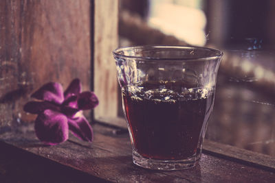 Close-up of glass of red wine on table