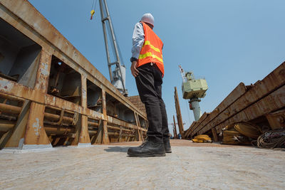 Rear view of man working at construction site