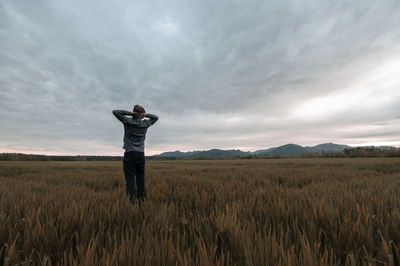 Full length of man standing on field against sky