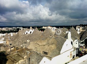 High angle view of cityscape against cloudy sky