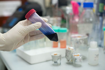 Cropped hands testing chemicals in laboratory