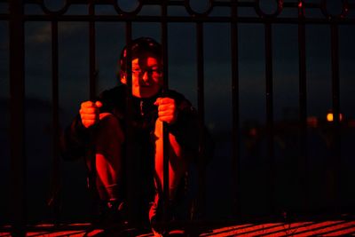 Portrait of man against illuminated lights