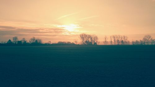 Scenic view of field against sky during sunset