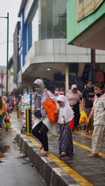 People walking on street in city