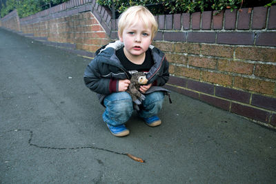 Portrait of boy sitting outdoors