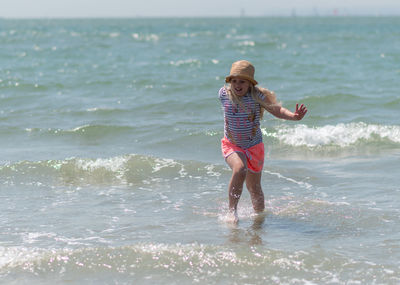 Full length of girl standing on beach