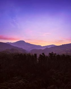 Scenic view of silhouette mountains against sky during sunset