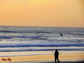 Scenic view of sea against clear sky during sunset