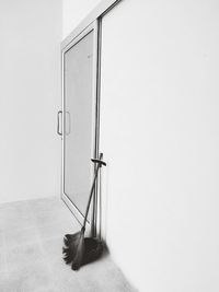 Ladder on floor against white wall