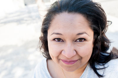 Close-up portrait of a smiling young woman