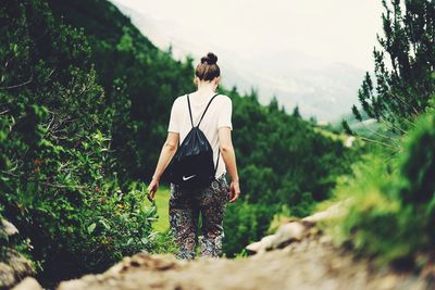 Rear view of woman in forest