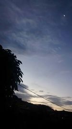 Low angle view of silhouette trees against sky at sunset