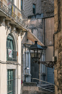 Low angle view of residential street with streetlight framed by older buildings in center of city