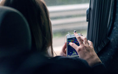 Rear view of man using mobile phone