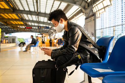 Side view of man using mobile phone