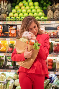 Portrait of woman holding fruits at market