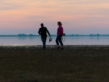 Couple taking pictures near the sea