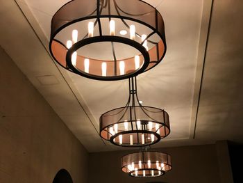 Low angle view of illuminated pendant light hanging from ceiling