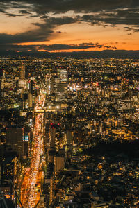 High angle view of illuminated cityscape against sky at night