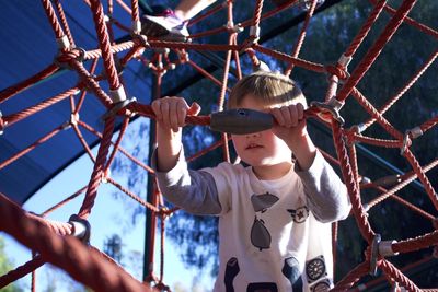 Boy playing at jungle gym