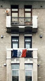 Low angle view of flags hanging on building