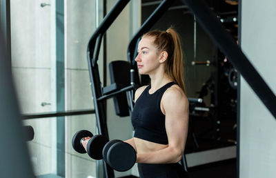 Young woman exercising at gym