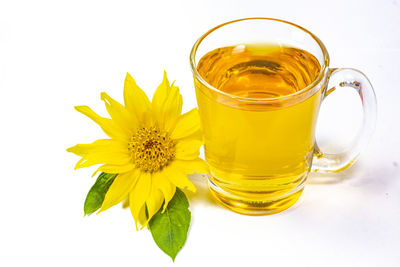 Close-up of yellow drink on white background