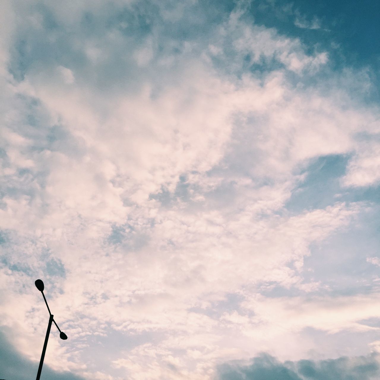 low angle view, sky, street light, cloud - sky, lighting equipment, cloudy, pole, cloud, nature, tranquility, electricity, outdoors, no people, beauty in nature, technology, day, scenics, blue, overcast, power line