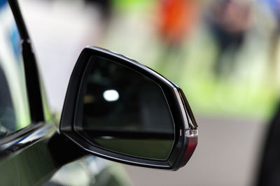 Close-up of side-view mirror of car