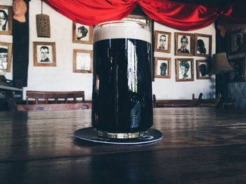 Drink on table against picture frames