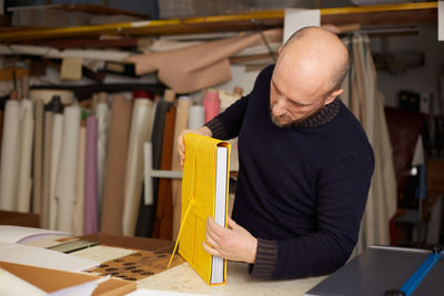 Man reading book at table