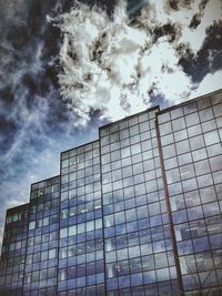 Low angle view of building against cloudy sky