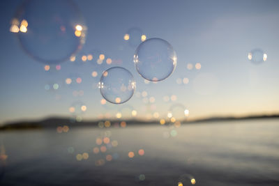 Close-up of bubbles against sky during sunset